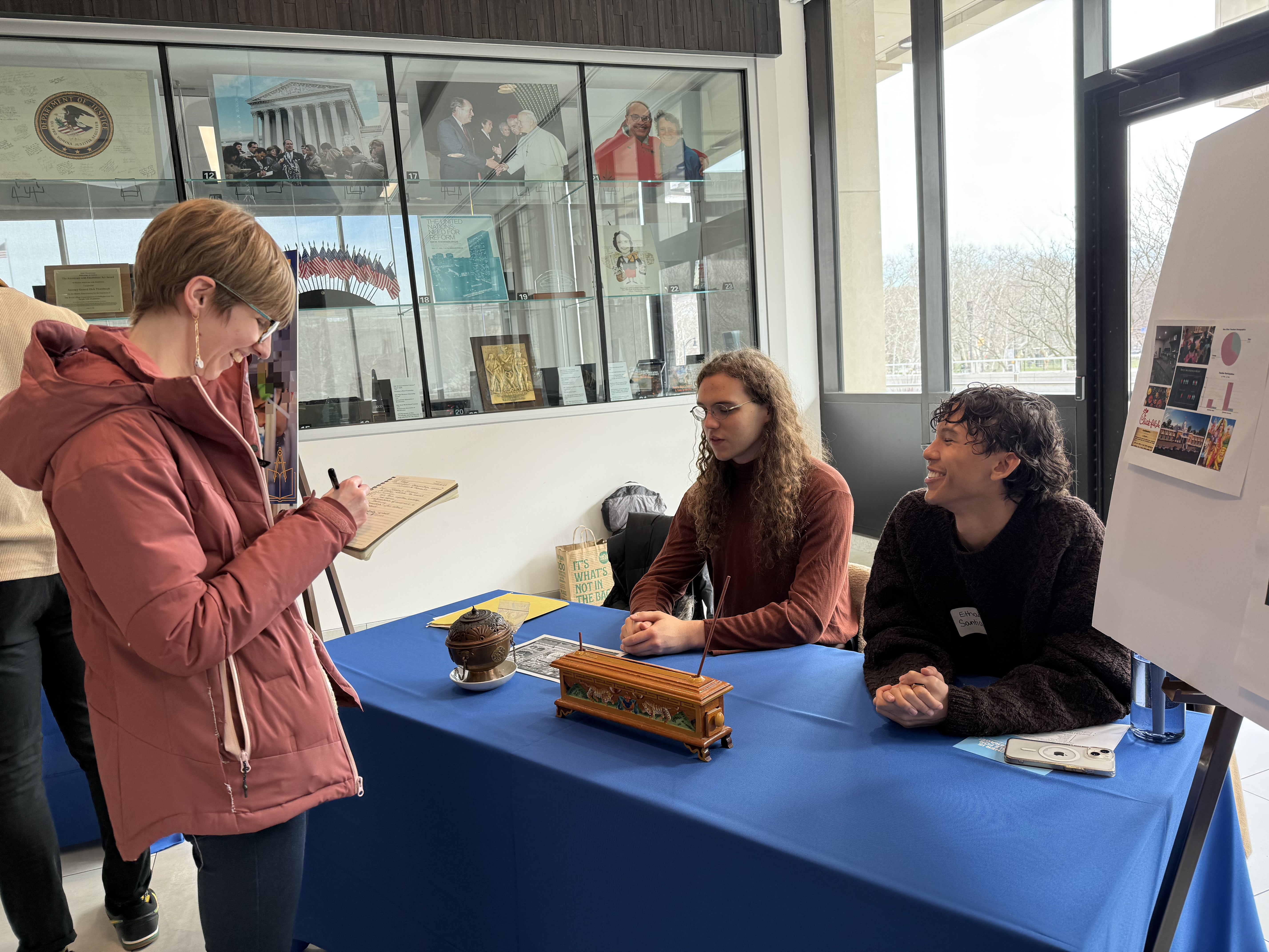 Students speak with an attendee