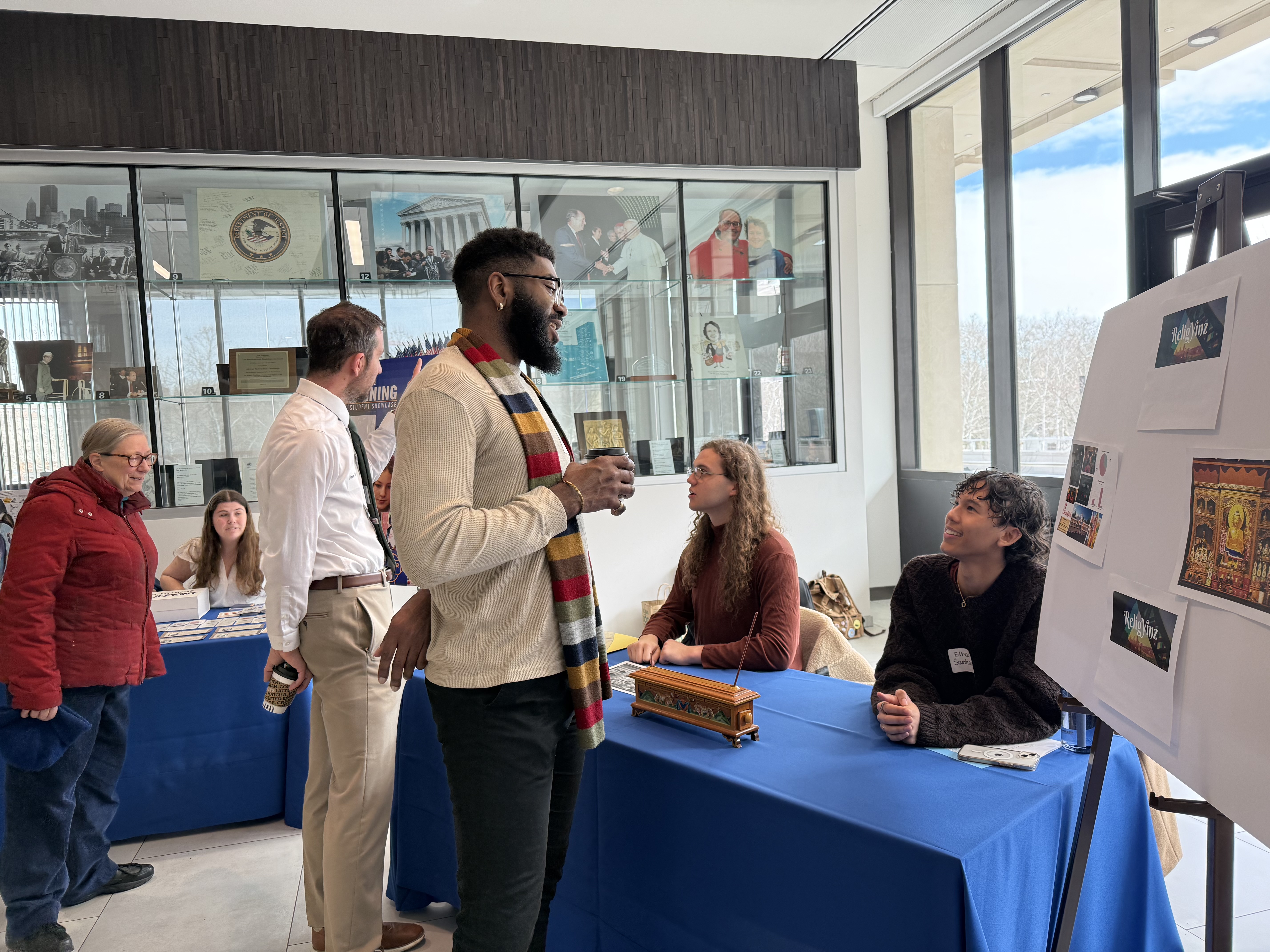 Students speak with an attendee