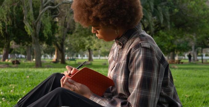 Student reading outdoors